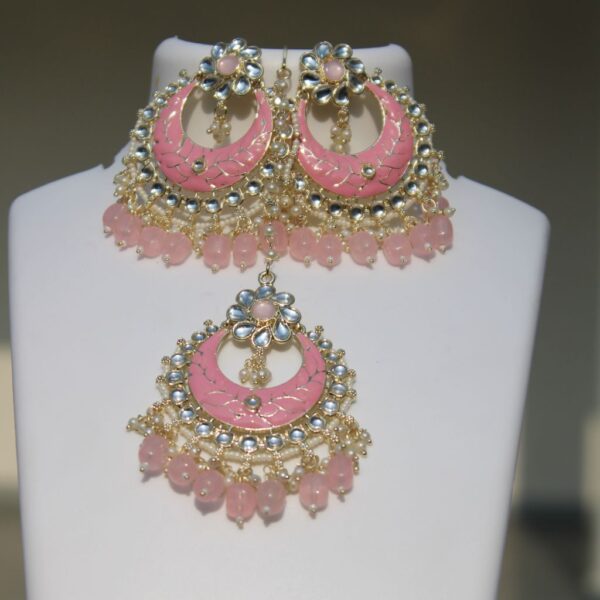 Pink meenakari chand bali kundan and pearls necklace set with maang tikka and earrings.