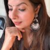 Black and silver oxidised statement jhumka earrings with intricate design and pearl detailing.