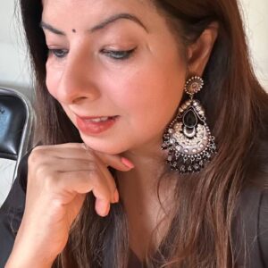 Black and silver oxidised statement jhumka earrings with intricate design and pearl detailing.