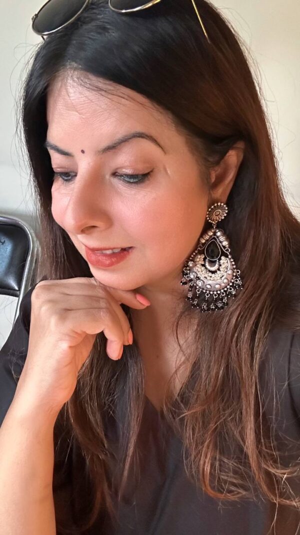 Black and silver oxidised statement jhumka earrings with intricate design and pearl detailing.